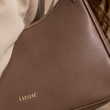 Close-up of LUSHÉ leather and gold lettering
