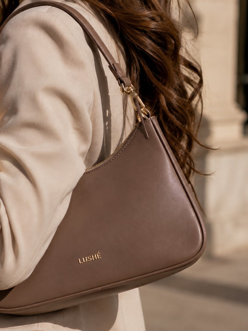 A LUSHÉ shoulder bag worn on the street
