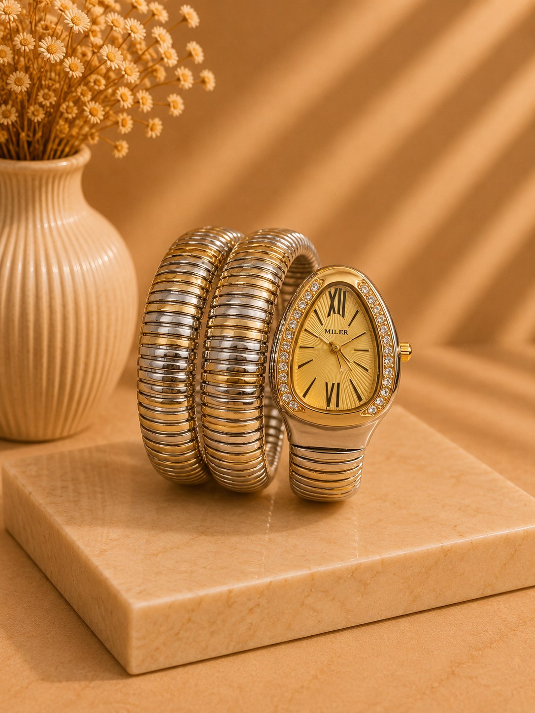 LUSHÉ Serpent Coil Watch in gold and silver with a crystal bezel